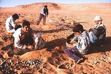 Group of nomads screening and digging for NWA 1110 Martian meteorite fragments.