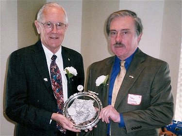 Moonwalker, Charles Duke (left) and Dr. Tony Irving presenting the Ambassador Slice at a promotional event for the Planetary Studies Foundation in Chicago.