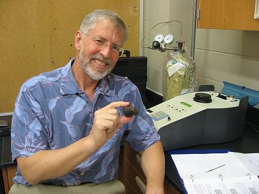 Dr. Dan Britt of UCF holding NWA 7007 to put in pycnometer for bulk density analysis.